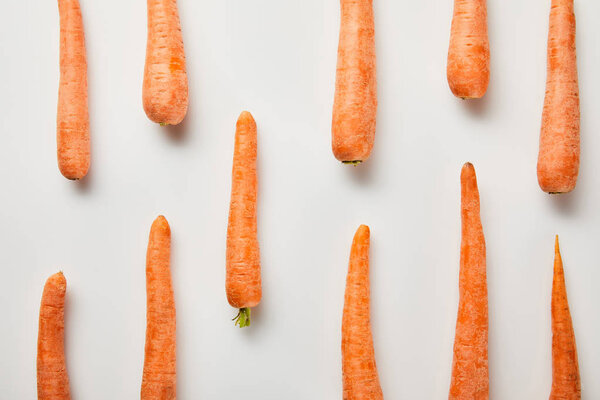 flat lay with fresh carrots on white background