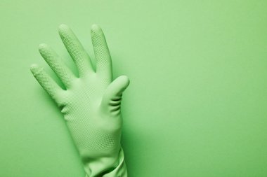 cropped view of man in rubber glove on green background  clipart