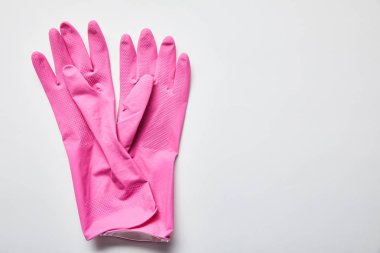 top view of pink rubber gloves on grey background with copy space  clipart