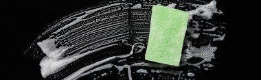 panoramic shot of green and colorful sponge with foam on black background  clipart