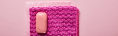 top view of pink rags and bright soap on pink background  clipart