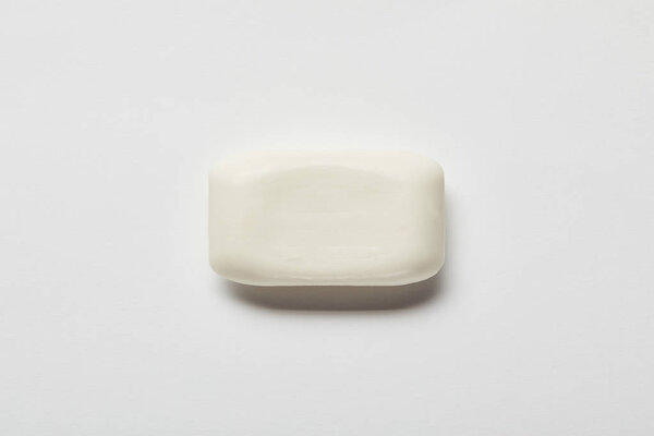 top view of white soap on grey background with copy space 