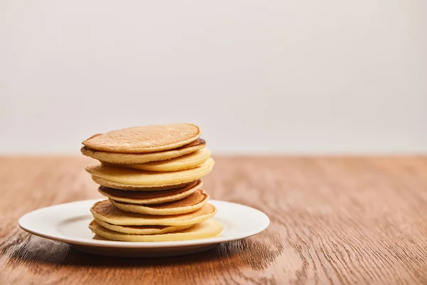 Many Tasty Pancakes White Plate Wooden Surface Isolated Grey — Stock Photo, Image