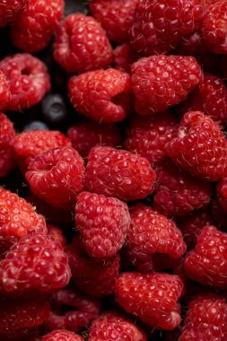 close up view of delicious ripe mixed raspberries and blueberries  clipart
