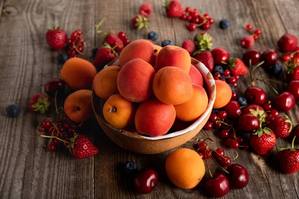 Reife Saisonale Beeren Verstreut Schüssel Mit Frischen Aprikosen Auf Holztisch — Stockfoto