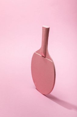 ping-pong racket on pink background with copy space clipart