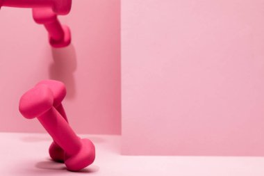 pembe parlak dumbbells kopya alanı ile pembe arka plan üzerinde havada uçan