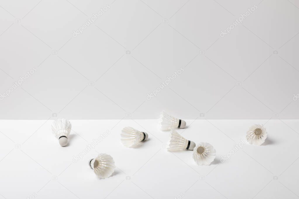 white badminton shuttlecocks scattered on white background