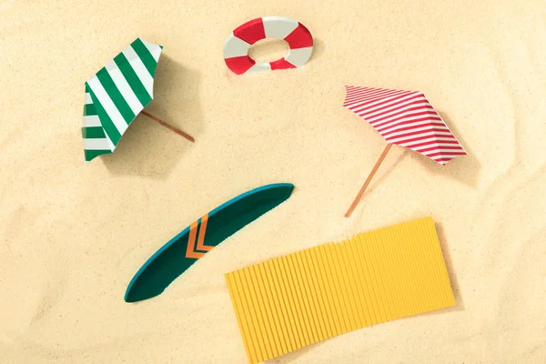 Top View Paper Beach Lifebuoy Umbrellas Surfboard Towel Textured Sand — Stock Photo, Image