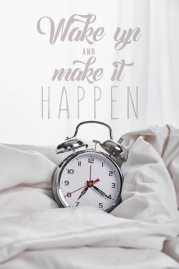 silver alarm clock in blanket in white bed with wake up and make it happen illustration clipart