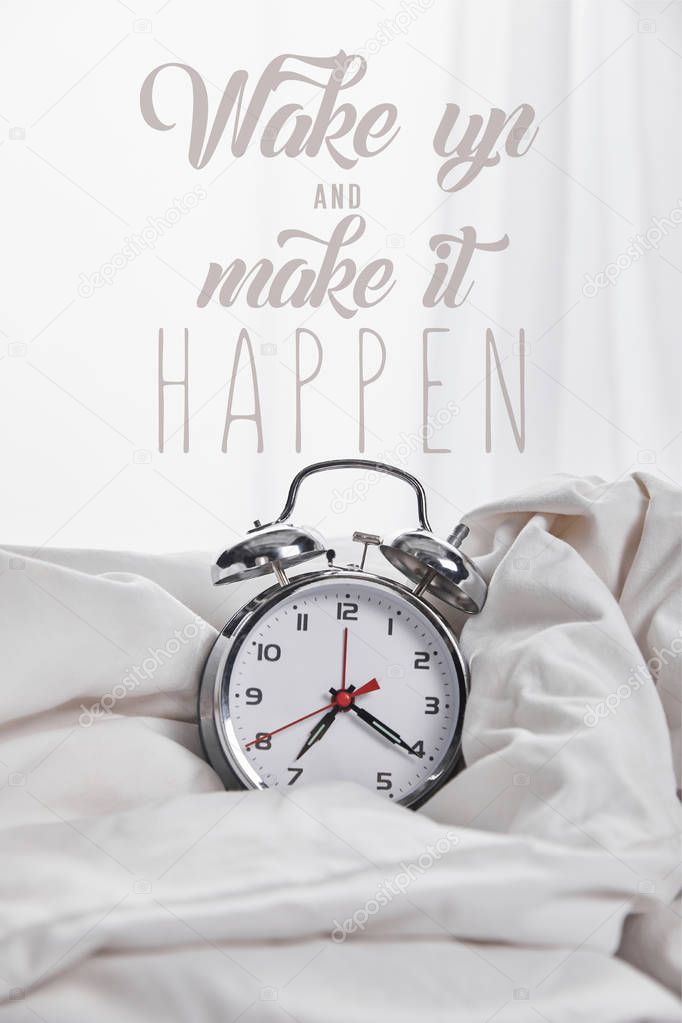 silver alarm clock in blanket in white bed with wake up and make it happen illustration