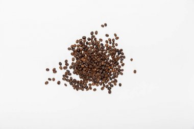 top view of scattered coffee grains on white background clipart