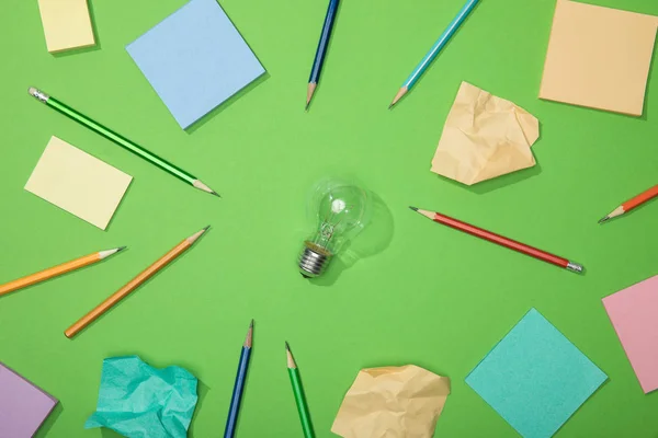 Top View Light Bulb Scattered Pencils Crumpled Paper Green — Stock Photo, Image