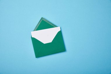 green envelope with blank white card on blue background clipart