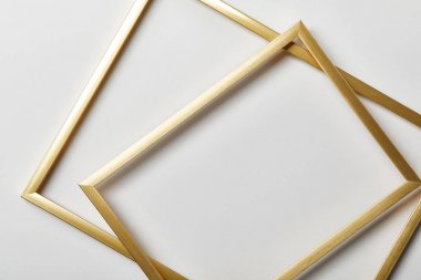top view of golden frames on white background with copy space clipart