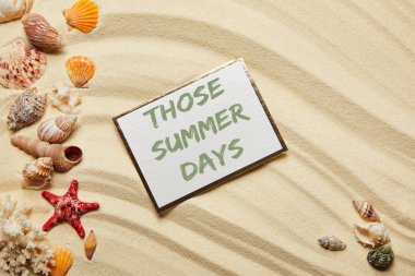 top view of card with those summer days lettering near seashells, red starfish and corals on sandy beach  clipart