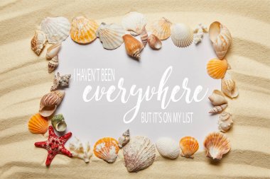 frame of seashells near placard with I have not been everywhere, but it is on my list letting on sandy beach clipart