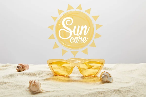 Yellow Stylish Sunglasses Sand Seashell Grey Background Sun Care Lettering — Stock Photo, Image