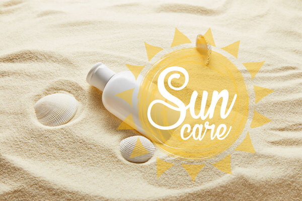 sunscreen in white bottle on sand with seashells and sun care lettering