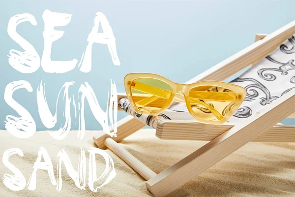 Yellow Stylish Sunglasses Deck Chair Sand Blue Background Sea Sun — Stock Photo, Image