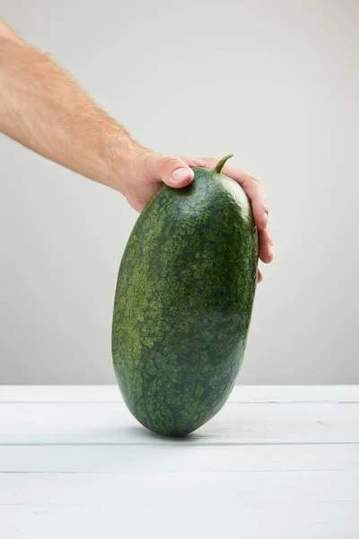 Cropped View Man Holding Ripe Whole Watermelon Wooden Table Isolated — Stock Photo, Image