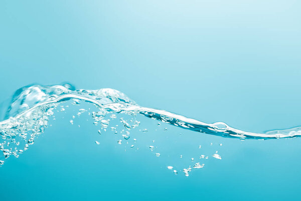 transparent pure wavy water with drops on blue background