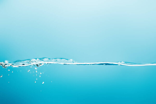 transparent pure water with droplets on blue background