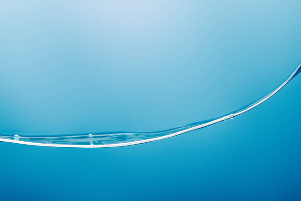 smooth transparent pure water wave on blue background