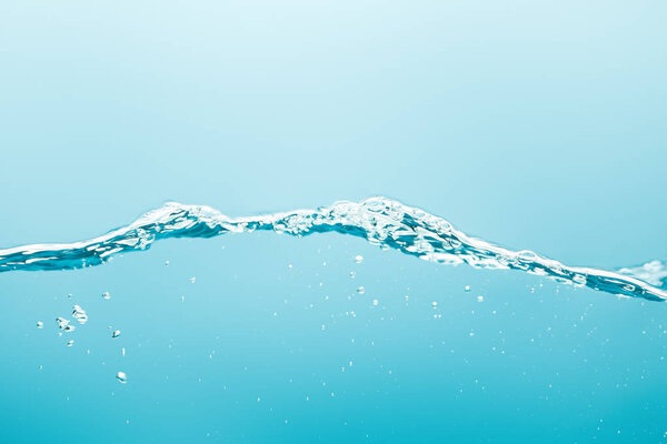 pure water with splash and bubbles on blue background