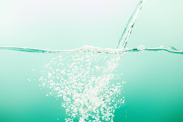 transparent pure water with stream and bubbles on green background