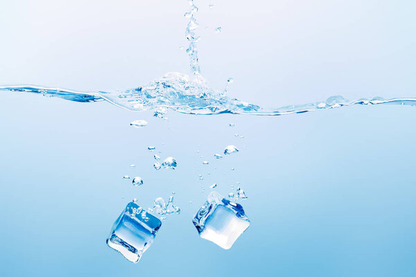 transparent pure water with splash and square ice cubes on blue background