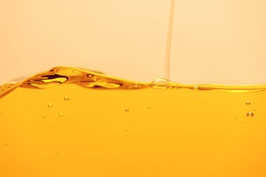 pouring yellow bright liquid with bubbles isolated on yellow clipart