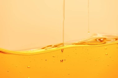 yellow bright liquid with bubbles and dripping drops isolated on yellow clipart