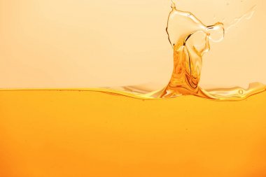 yellow bright liquid with splash isolated on yellow clipart