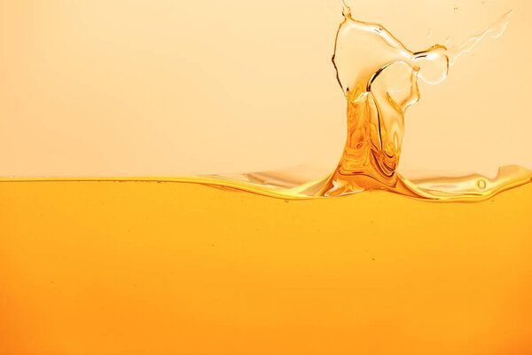 yellow bright liquid with splash isolated on yellow