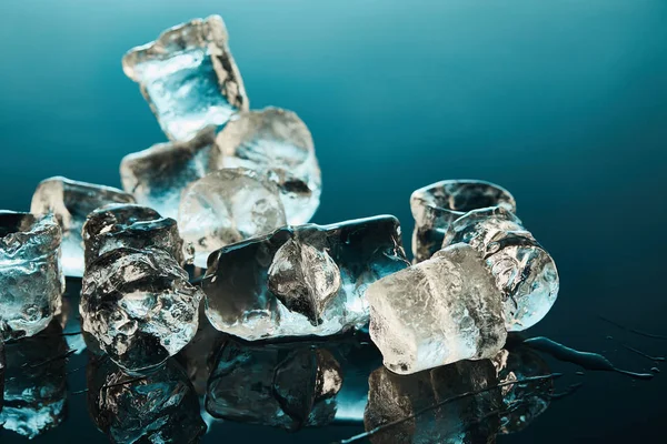 Stack Transparent Melting Ice Cubes Emerald Background — Stock Photo, Image