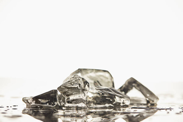 stack of transparent melted ice cubes on white background