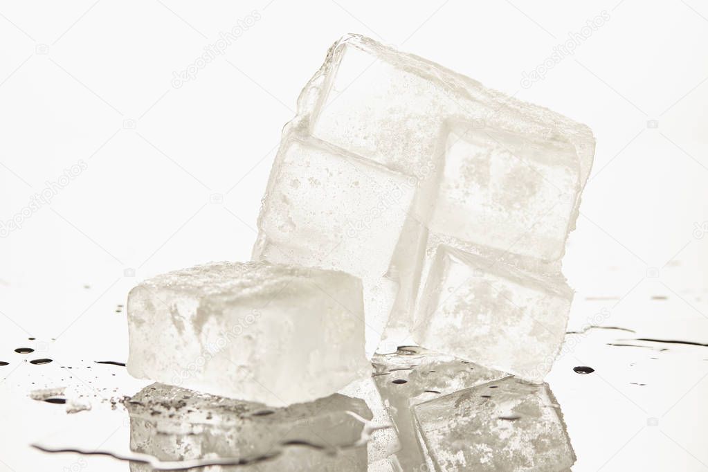 stack of transparent melting ice cubes on white background