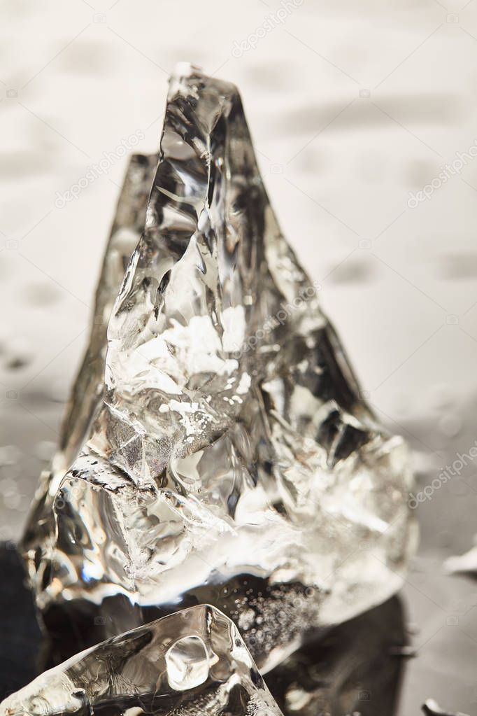 close up view of pure melting ice cube with drops