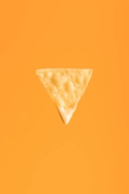 top view of crispy nacho isolated on orange, Mexican cuisine clipart