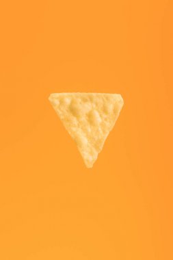 top view of crispy corn nacho isolated on orange, Mexican cuisine clipart