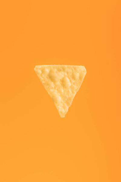 top view of crispy corn nacho isolated on orange, Mexican cuisine