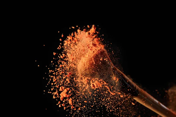 Cosmetic Brush Bright Orange Powder Explosion Black Background — Stock Photo, Image