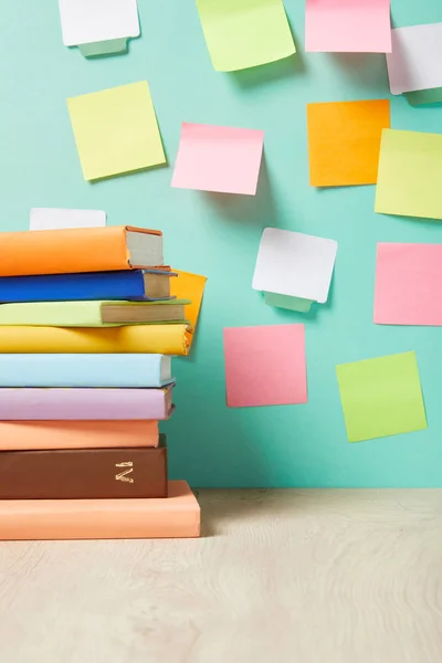 Stack Books Table Multicolored Sticky Notes Turquoise Wall — Stock Photo, Image