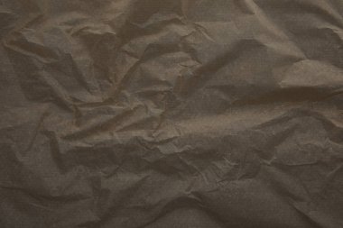 top view of dark beige crumped parchment paper surface with copy space clipart
