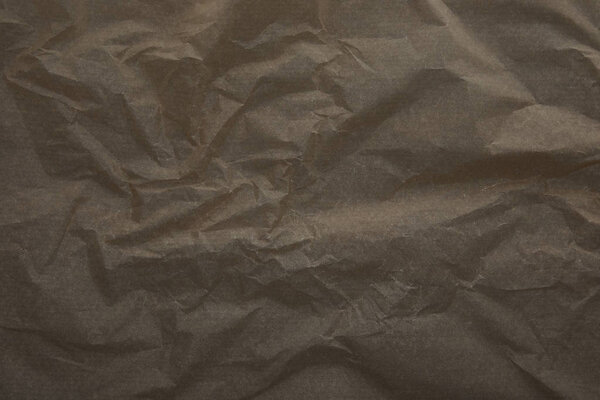 top view of dark beige crumped parchment paper surface with copy space