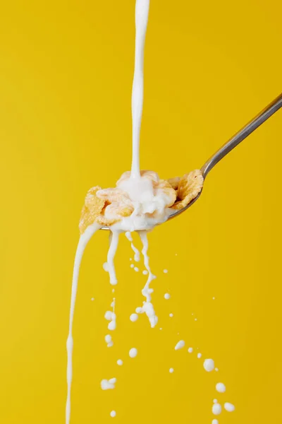 Cucchiaio Con Fiocchi Mais Flusso Latte Con Spruzzi Isolati Giallo — Foto Stock