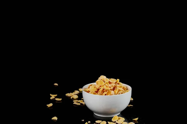 Vit Skål Med Cornflakes Och Spridda Bitar Isolerade Svart — Stockfoto