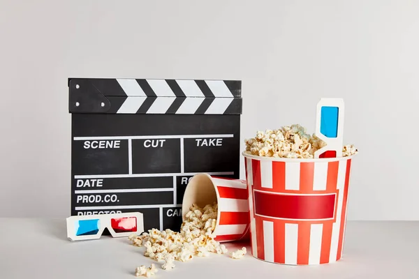 Delicious Popcorn Scattered Buckets Clapper Board Glasses Isolated Grey — Stock Photo, Image