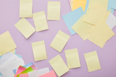 top view of colorful sticky notes isolated on purple  clipart